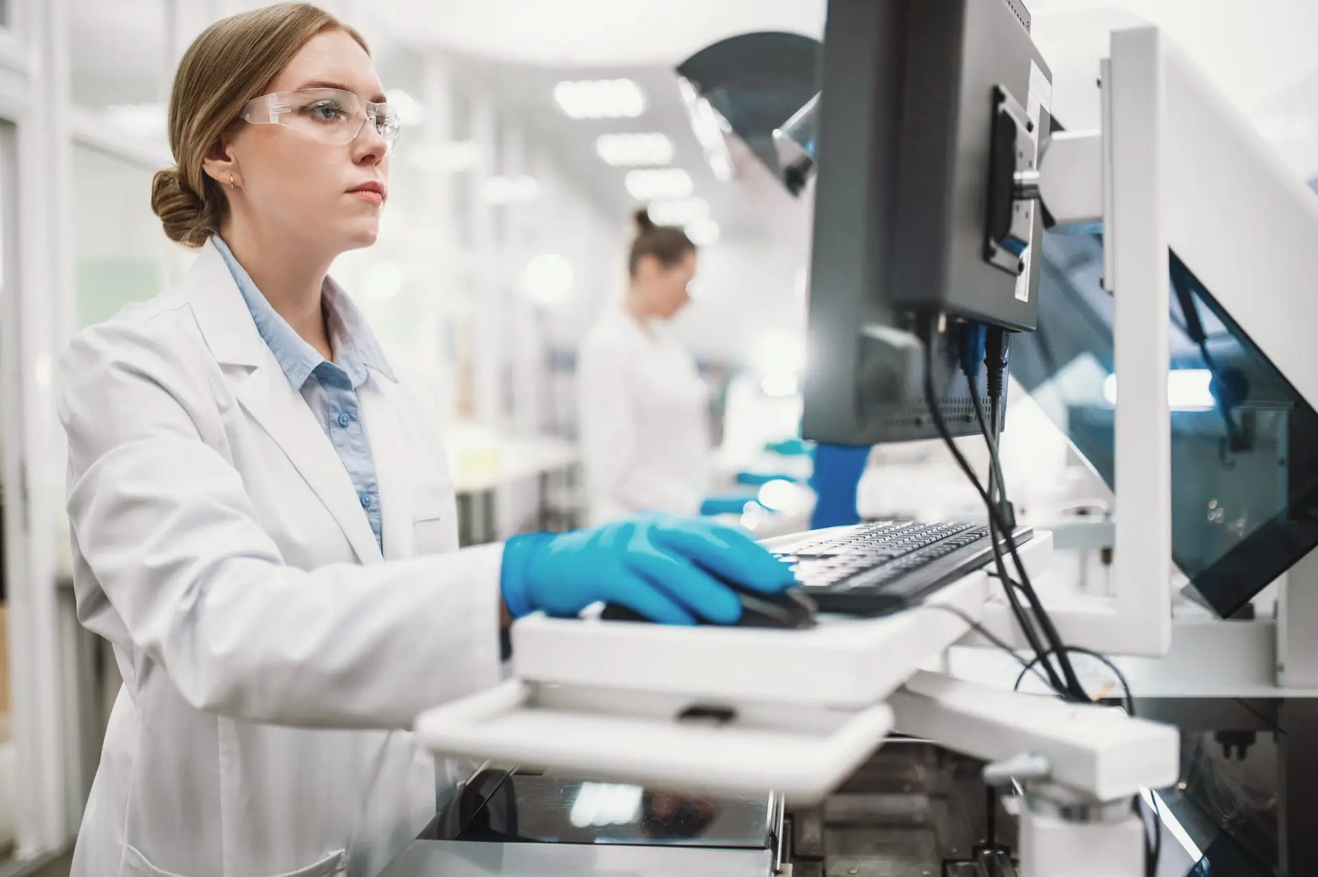 A medical technologist working on a computer